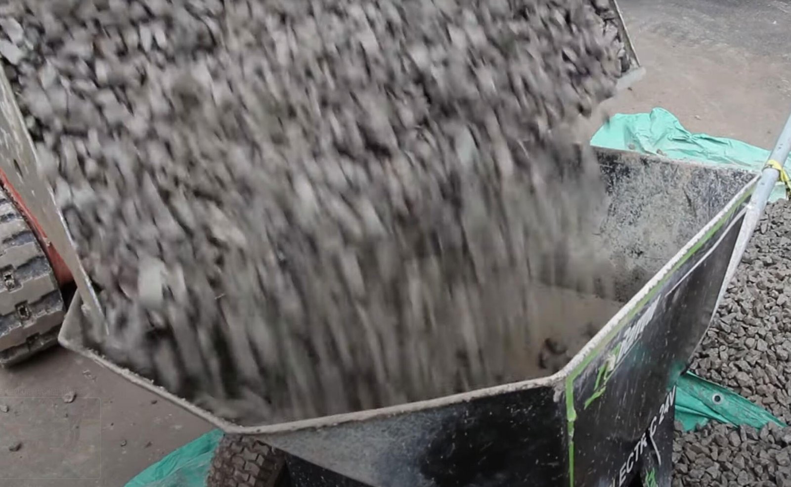 Electric wheelbarrow is loading concrete